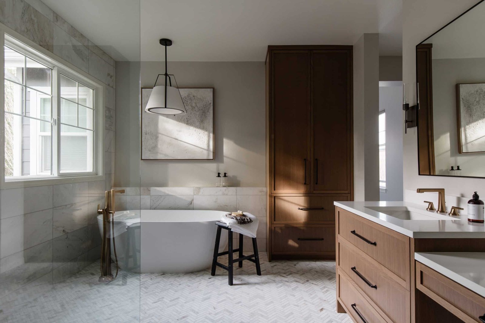 Remodeled bathroom with freestanding tub, walk-in shower and wood vanity